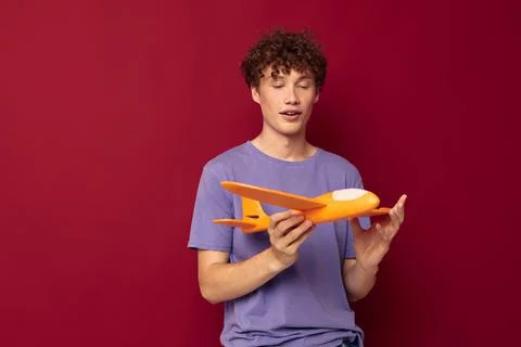 Young guy yellow plane posing fun isolated background unaltered Stock Photos