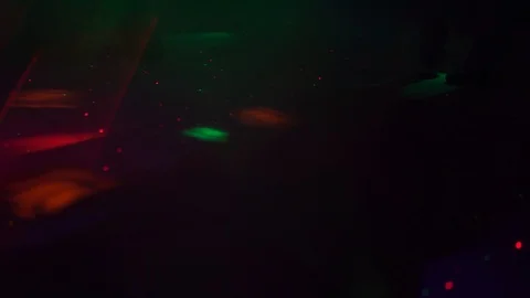 Young guys are dancing in the colored lights of a nightclub. Stock Footage 100347710