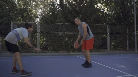 Young guys are training to play on the playground in basketball score goals Stock Footage 110617935