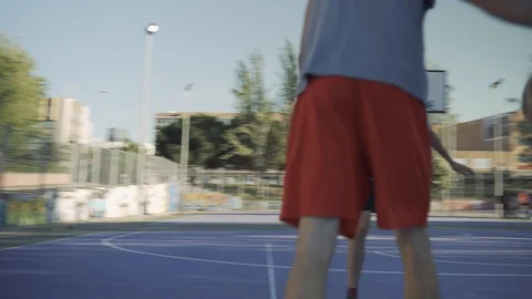 Young guys are training to play on the playground in basketball score goals Stock Footage 110617948