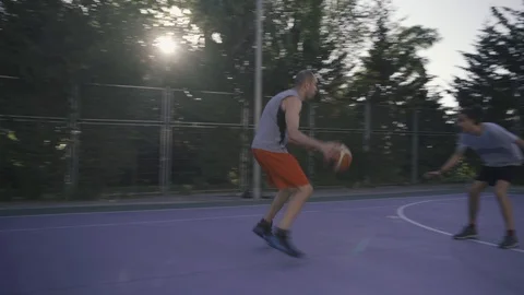 Young guys are training to play on the playground in basketball score goals Stock Footage 110617991