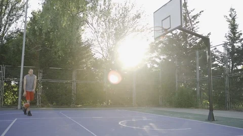Young guys are training to play on the playground in basketball score goals Stock Footage 110618006