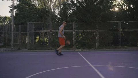 Young guys are training to play on the playground in basketball score goals Stock Footage 110618007