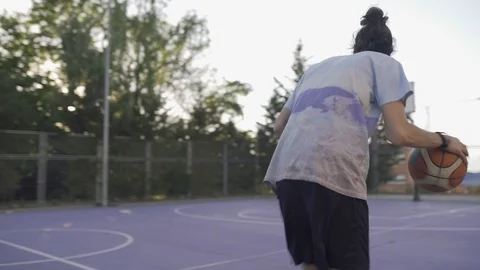 Young guys are training to play on the playground in basketball score goals Stock Footage 110618019