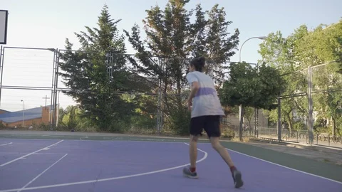 Young guys are training to play on the playground in basketball score goals Stock Footage 110618027