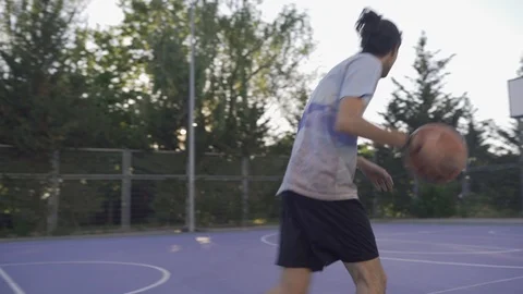 Young guys are training to play on the playground in basketball score goals Stock Footage 110618032