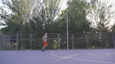 Young guys are training to play on the playground in basketball score goals Stock Footage 110618037