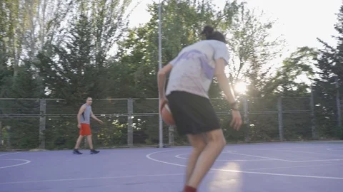 Young guys are training to play on the playground in basketball score goals Stock Footage 110618047