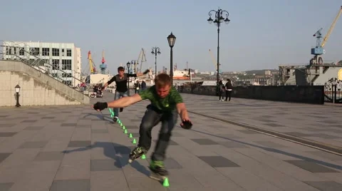 Young guys doing tricks on roller skates Stock Footage 63363669