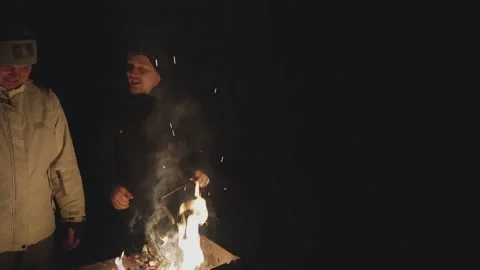 Young guys in front of the barbecue communicate, kindling a fire Video stock 231707385