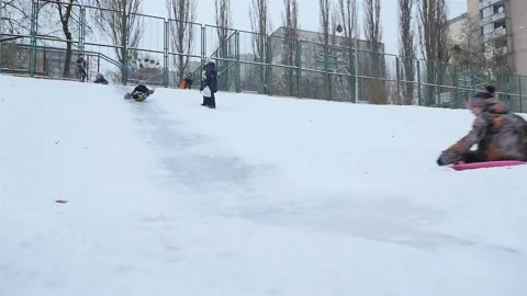 Young guys go down the icy hill. Slow motion 01.10.2020 Ukraine, Kiev Stock Footage 126642220