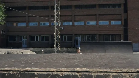 Young guys jumping and doing tricks on a scooter. Video stock 94142566
