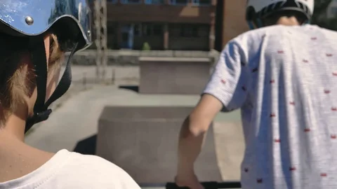 Young guys jumping and doing tricks on a scooter. Video stock 94142894