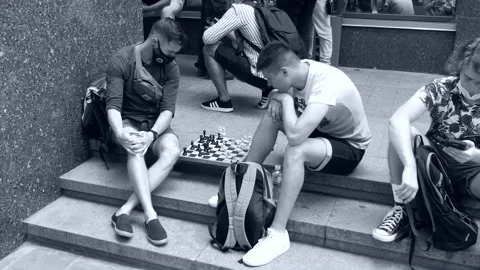 Young guys - students play chess with interest on the steps of the institute. Stock Footage 134262070