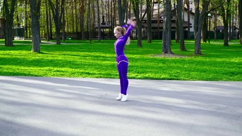 Young gymnast dancing in the park Stock Footage 75421692
