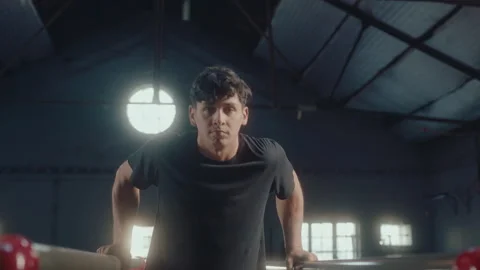 Young Gymnast Doing Parallel Bar Dips with L-Sit Leg Raise Video stock 258405796