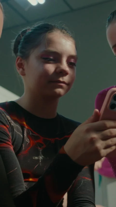 Young Gymnasts Rest in Dressing Room and Watching Video From Tournament on Stock Footage 339647274