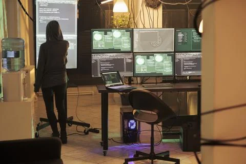 Young hacker analyzing script to crack security system and access network Stock Photos