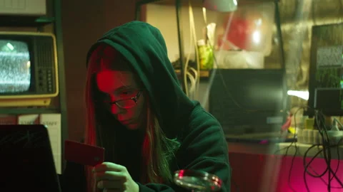 Young hacker breaking password of credit bank card. Woman programmer infecting Stock Footage 159415878