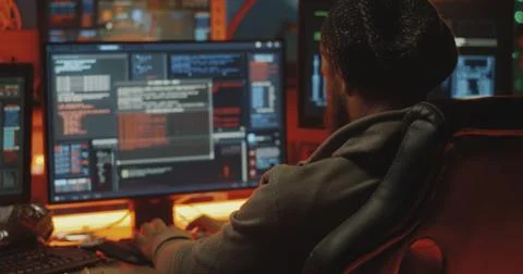 Young hacker coding on his computer Stock Photos