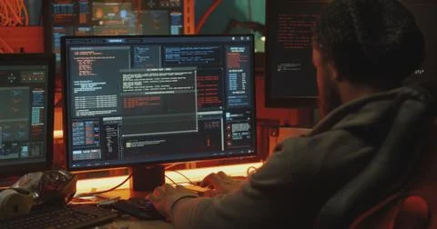 Young hacker coding on his computer Foto stock