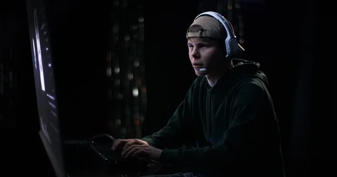 Young hacker communicating via headset Stock Footage 101400627