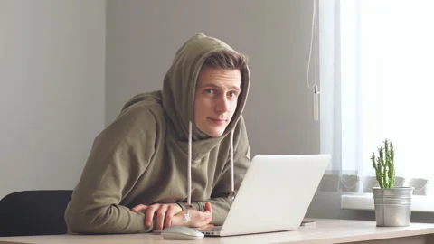 Young hacker concentrated on coding, hacker looking at screen monitoring stock Stock Footage 102828716