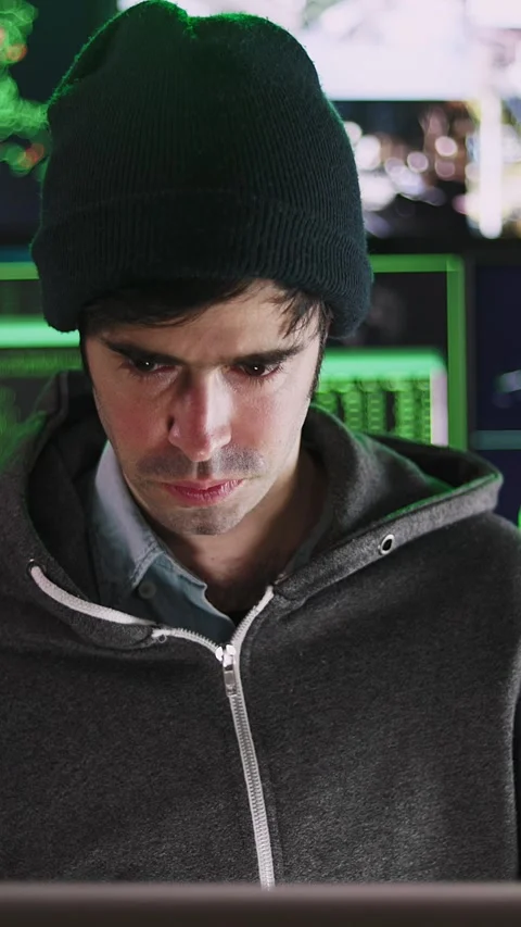 Young hacker man breaking into corporate servers from his home office Stock Footage 316850063