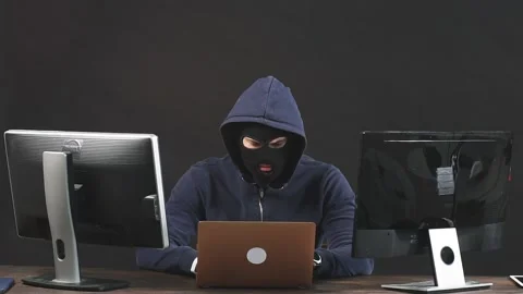 Young hacker man in mask sit in space full of money Stock Footage 123475664