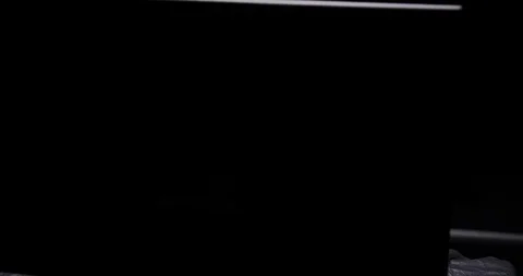 Young hacker programming behind a computer screen Stockbeeldmateriaal 105580966