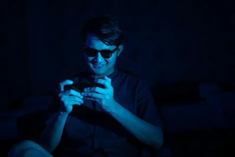 Young hacker style using mobile phone to access data Stock Photos