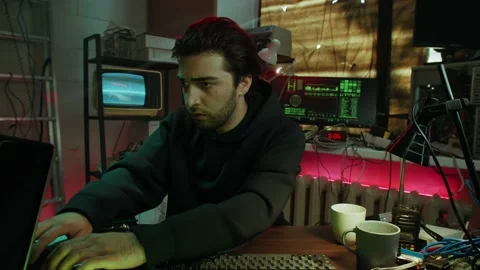 Young hacker typing on keyboard at night, breaking password, using laptop and Stock Footage 158621481
