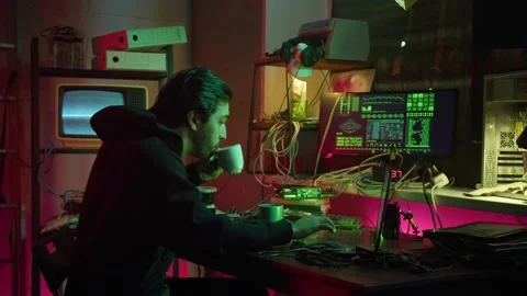 Young hacker typing on keyboard at night, breaking password, using laptop and Stock Footage 158621504