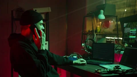 Young hacker typing on keyboard at night, breaking password, using laptop and Stock Footage 160941502