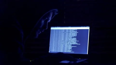 Young hacker working on secret codes to a computer Stockbeeldmateriaal 71029691
