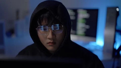 Young hacker writing malicious software code, focusing on cyberattack, security Stock Footage 313825026