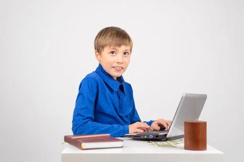 The young hacker: a Young smart boy with a netbook recklessly happy with his  Foto stock