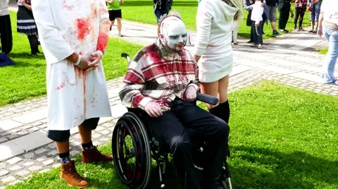 Young handicap guy participating in preparation, make up phase of zombie walk Stock Footage 68703282
