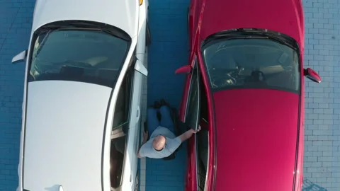 Young handicapped driver getting in red car from wheelchair Stock Footage 160074095