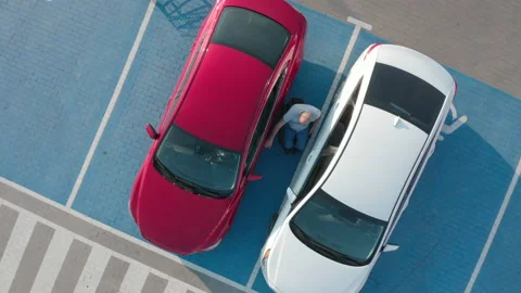 Young handicapped driver getting in red car from wheelchair Stock Footage 160074113