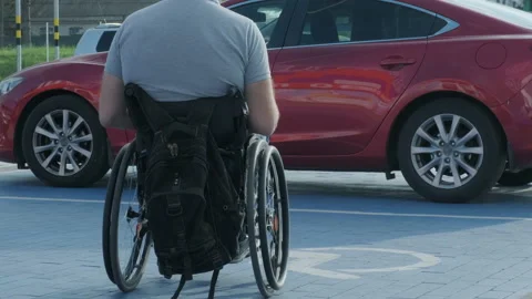 Young handicapped driver getting in red car from wheelchair Stock Footage 160645708