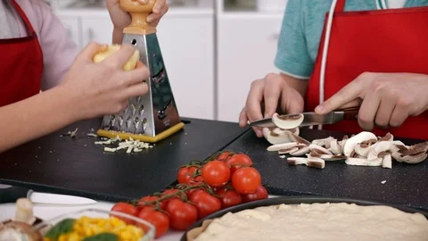 Young hands making pizza in the kitchen - preparing the ingredients Video stock 103175691