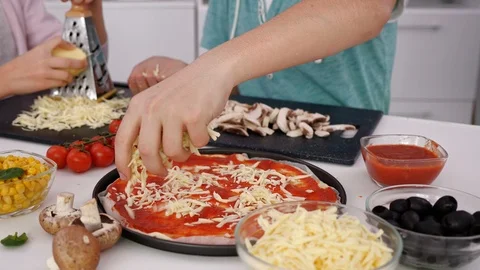 Young hands making pizza preparing the ingredients - camera slide Stock Footage 103175751