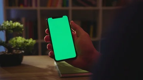 Young hands man hold phone with vertical green screen use touch digital Stock Footage 121814669