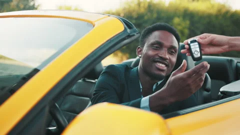 Young handsome African businessman in a Car Rental Service. Test Drive Concept Stock Footage