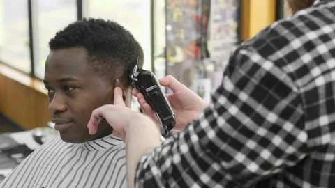 Young handsome african man making a haircut with a cheerful face and laughing. A Stock Footage 169192391