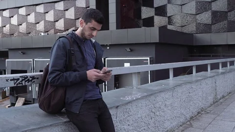 Young handsome arabic man using smartphone in city Stock Footage 88773585