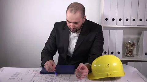 Young handsome architect job working on blueprints drawing house construction 4K Stock Footage 72900604