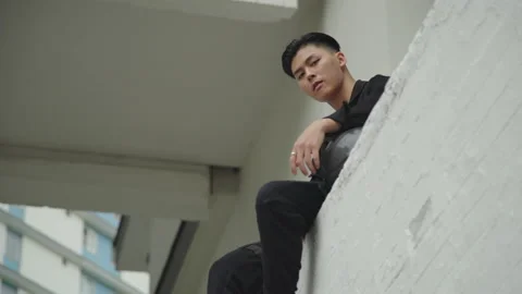 Young handsome asian guy is looking at camera seriusly Stock Footage 159024963