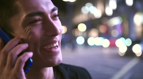 Young handsome asian man using his phone at night in the city Stock Footage 46951939